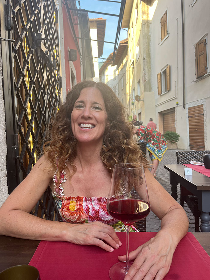Danielle in Italy with a glass of red wine