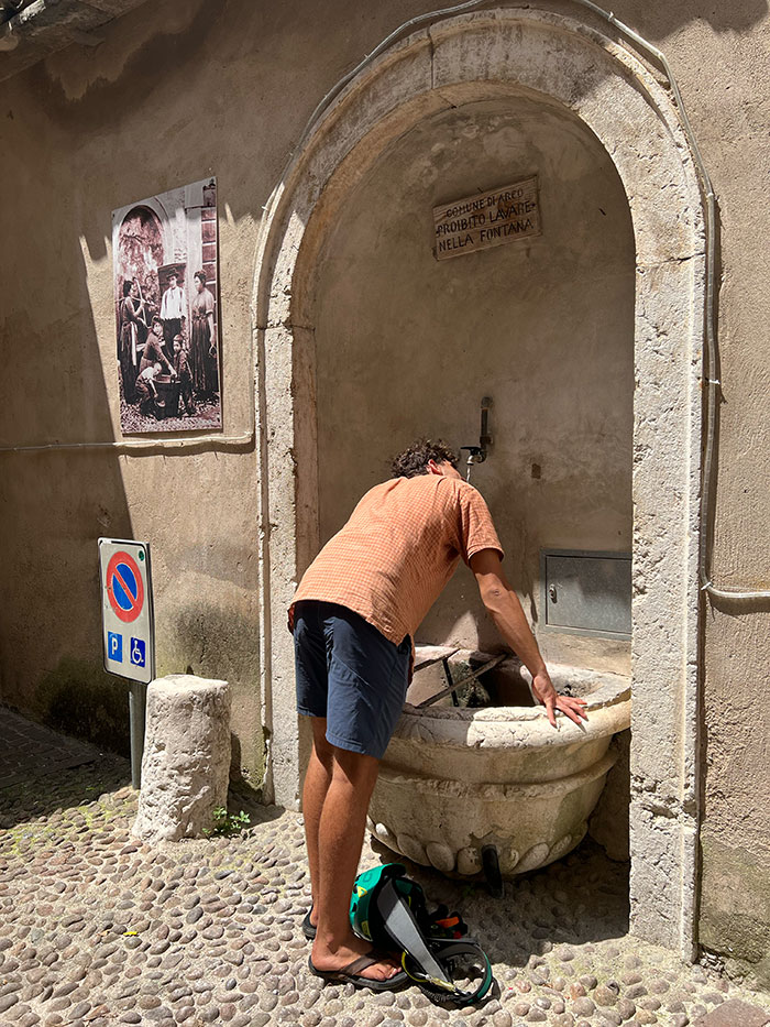 Man drinking from a water fountain