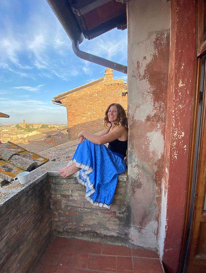 Danielle sitting on a balcony overlooking an Italian city